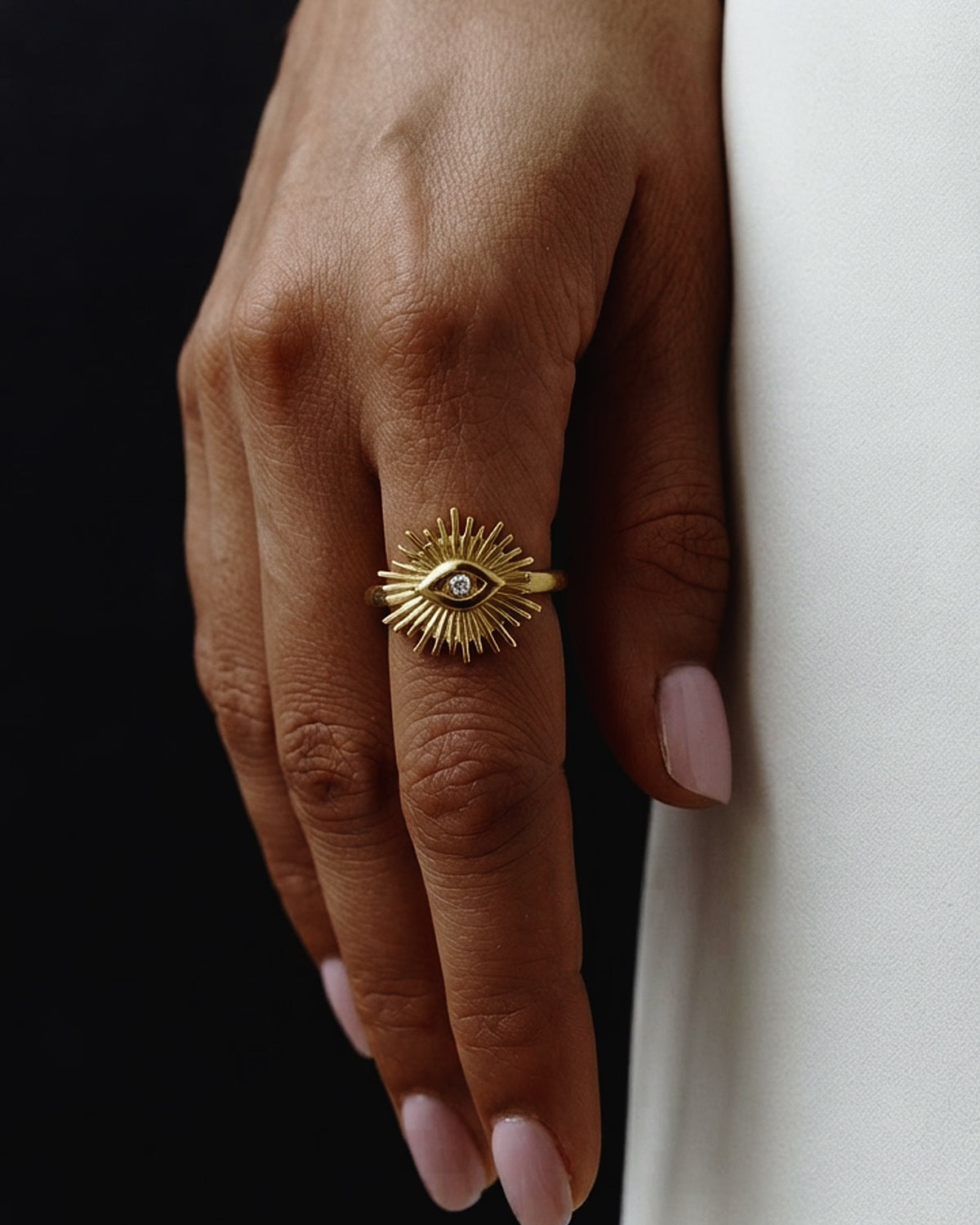 A radiant sunburst eye medallion on a slender, everyday band. Anti-tarnish, waterproof gold-tone stainless steel. Shop Zorelle India.